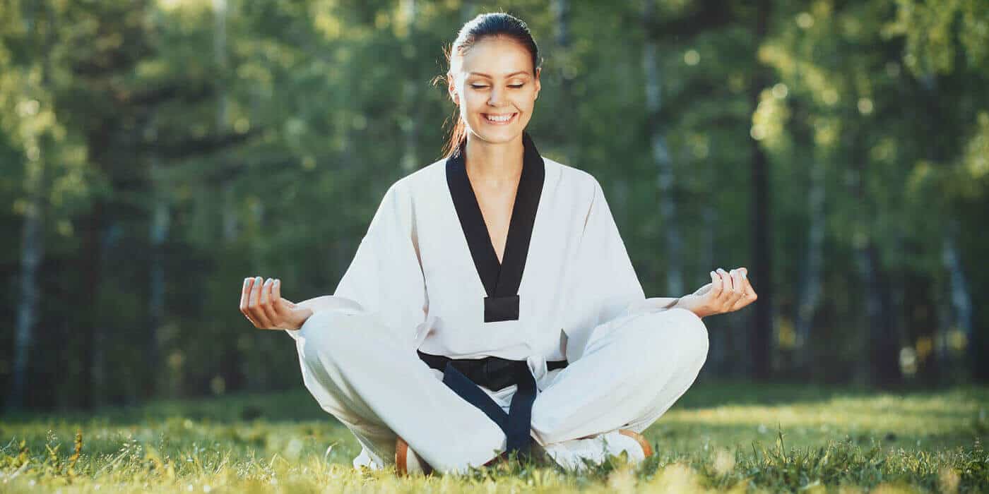 Martial Arts Lessons for Adults in __CITY__ __STATE__ - Happy Woman Meditated Sitting Background